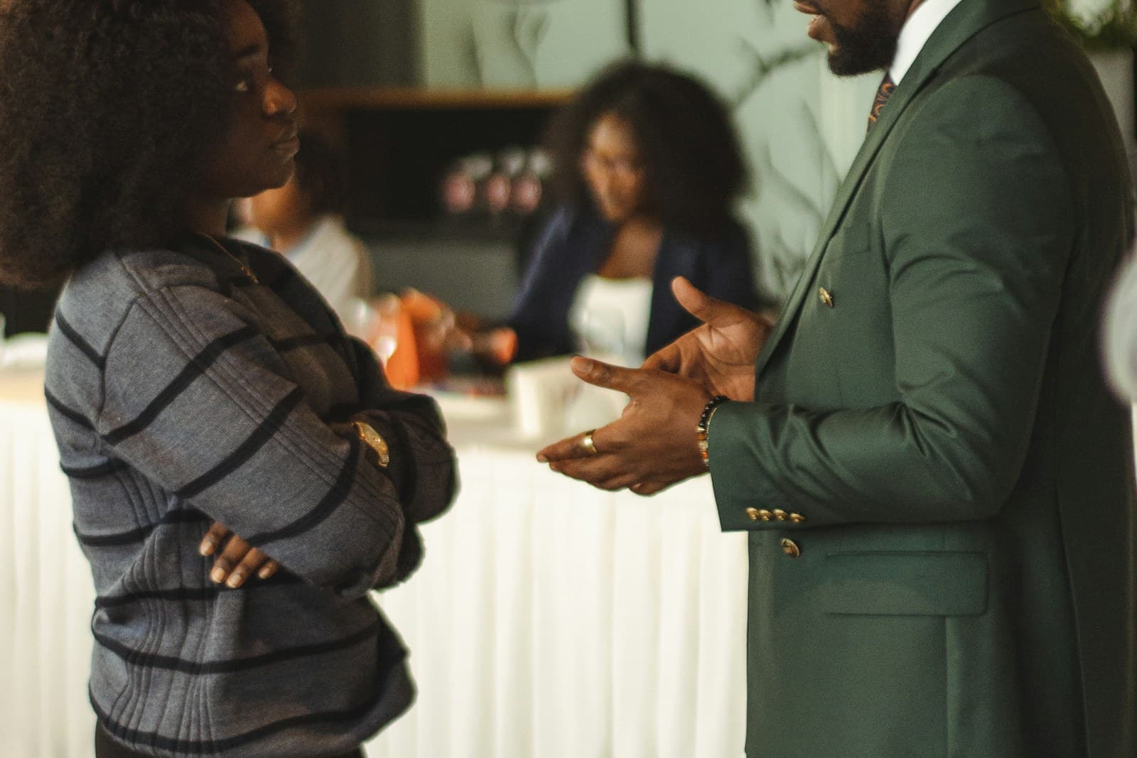 Two professionals having a conversation in a meeting room